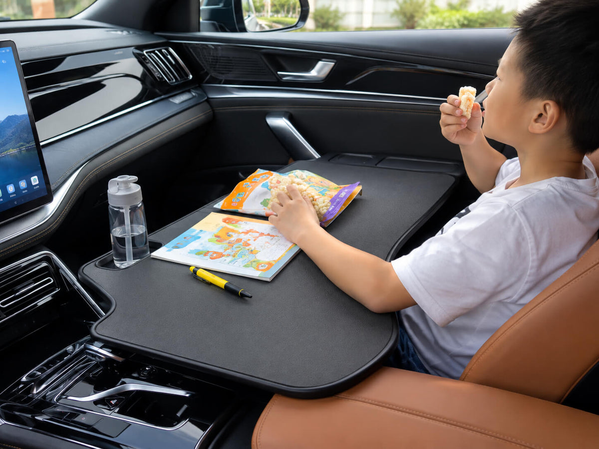 Black folding car table for BYD Leopard 5 and Leopard 8 used for children's activities inside the car.