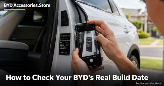 Owner photographing the vehicle identification nameplate on a BYD B-pillar to check the build date