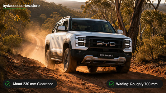 BYD Shark 6 driving a red-dirt bush track, showing its off-road clearance and capability