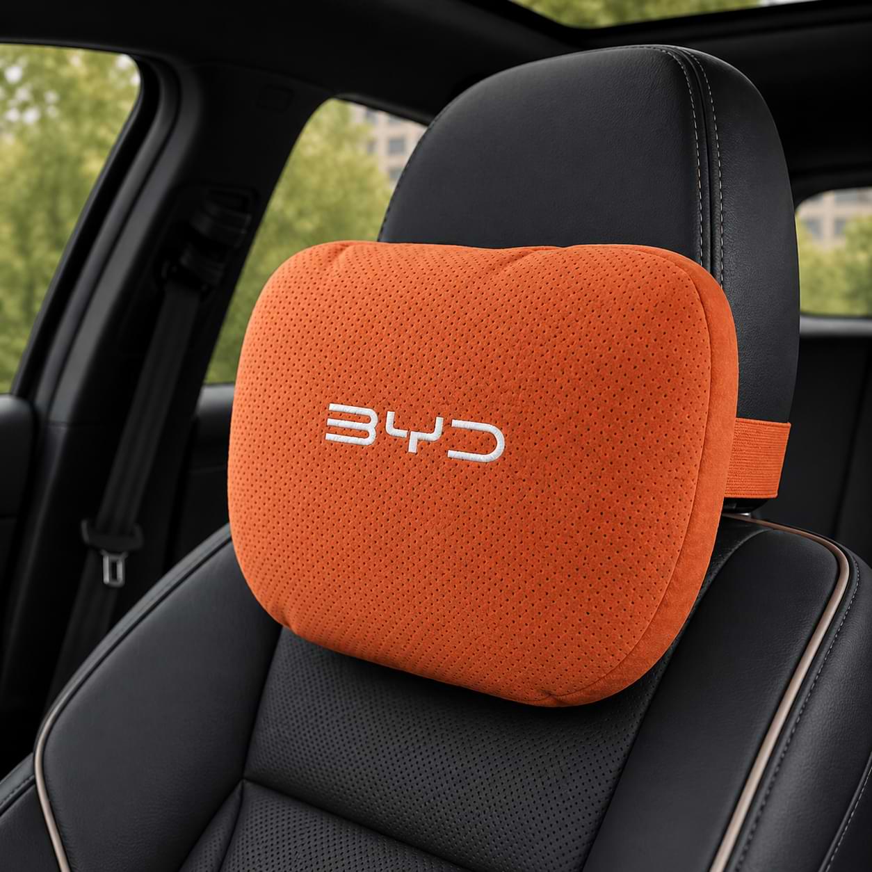 Orange car headrest pillow with BYD logo on a black car seat