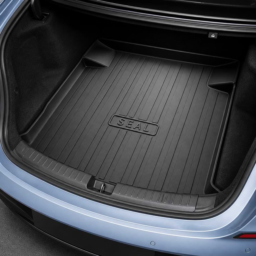 Car trunk with a black cargo liner labeled 'SEAL' on a gray car exterior.