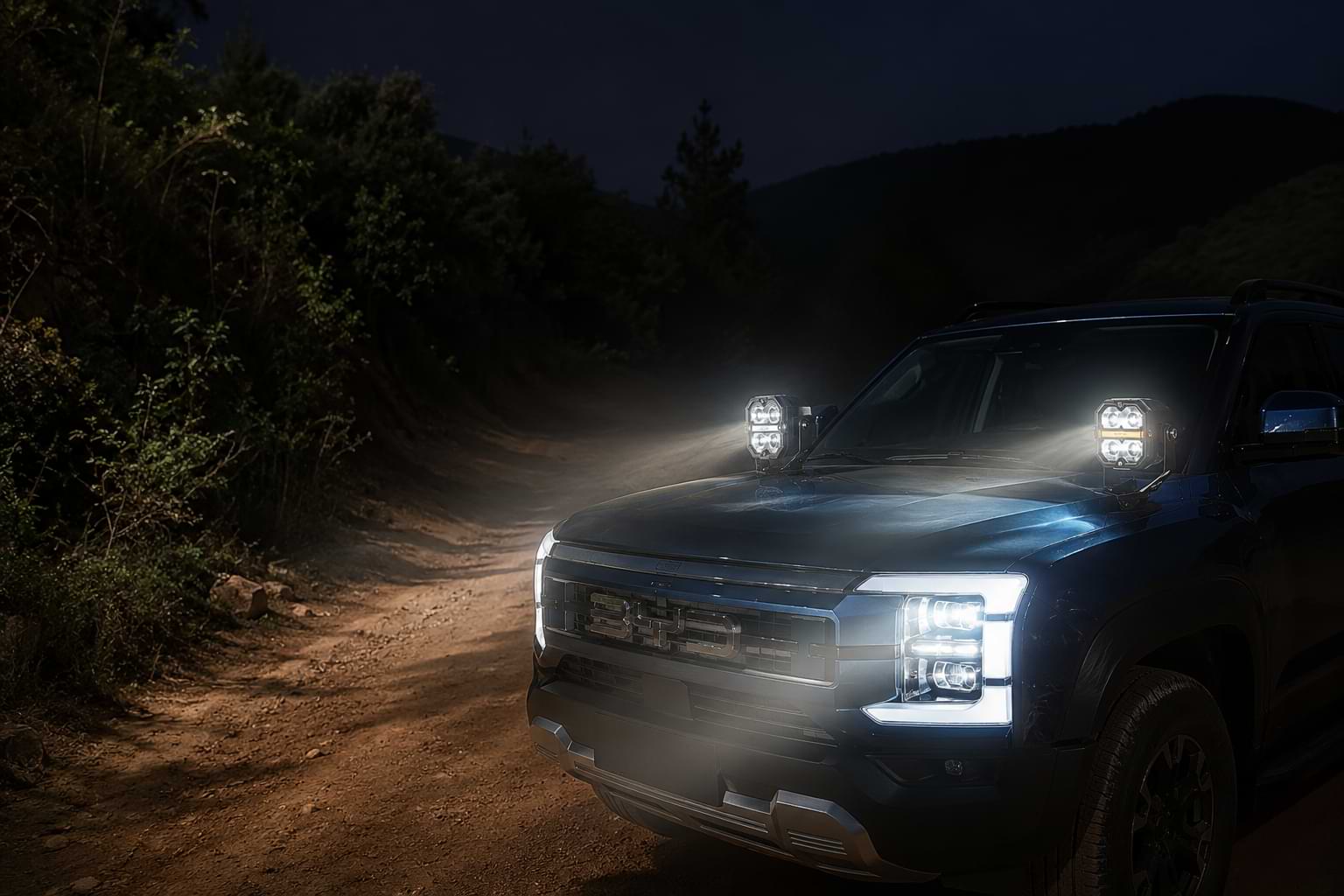 BYD Shark 6 driving at night with bright LED work lights mounted on A-pillar spotlight brackets